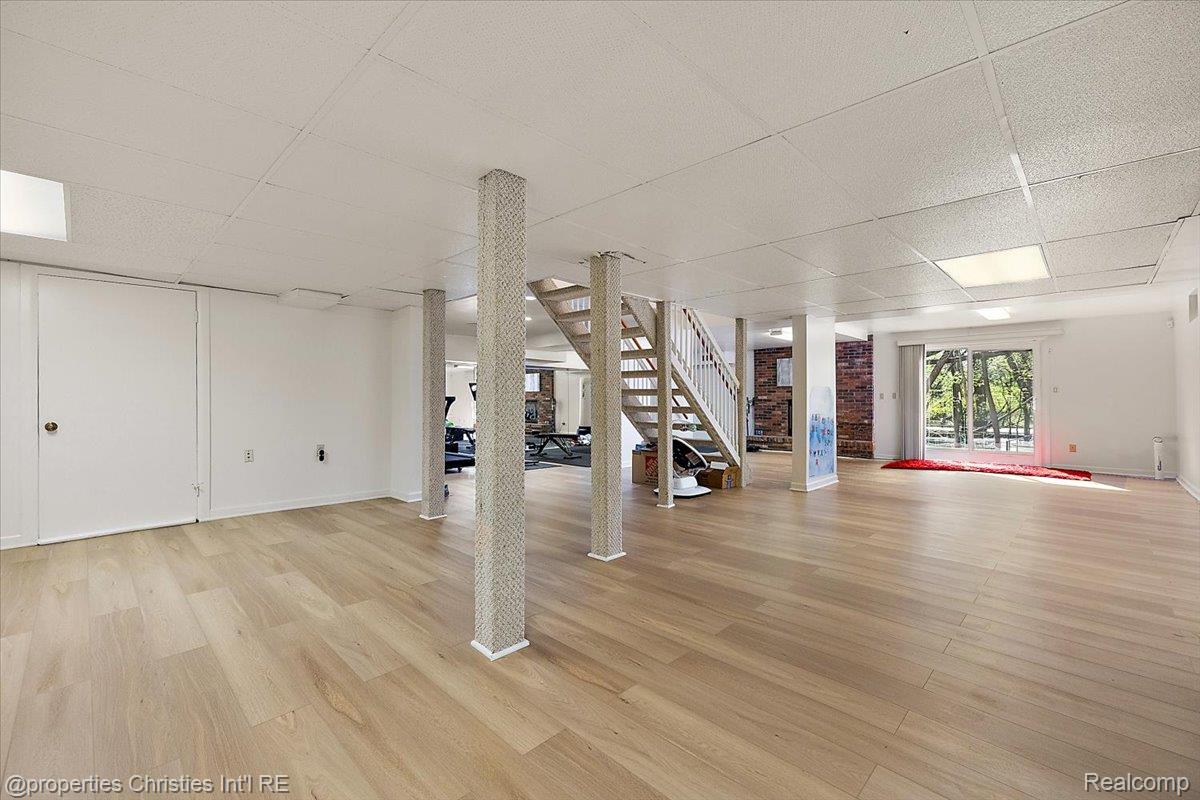 1830 Lone Pine Road Bloomfield Hills, MI 48302 - Photo 37 of 49 Below grade area with a paneled ceiling and light wood-style floors