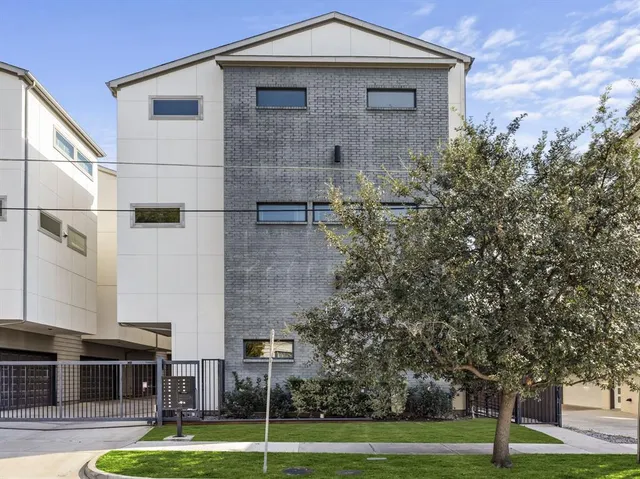 a front view of a building with trees