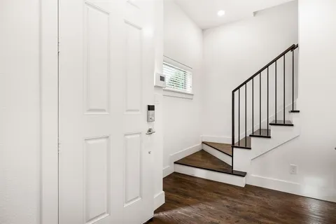 wooden floor with staircase and windows