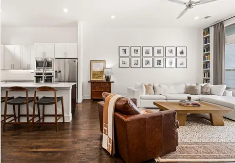 a living room with furniture window and wooden floor