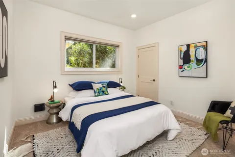 a bedroom with a bed and a painting on the wall