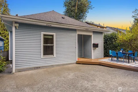 a view of a house with a patio and a yard