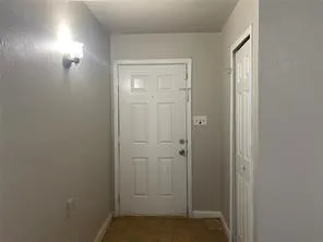 an empty room with a ceiling fan and a window