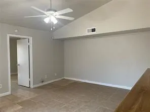 a kitchen with a stove and a wooden floor