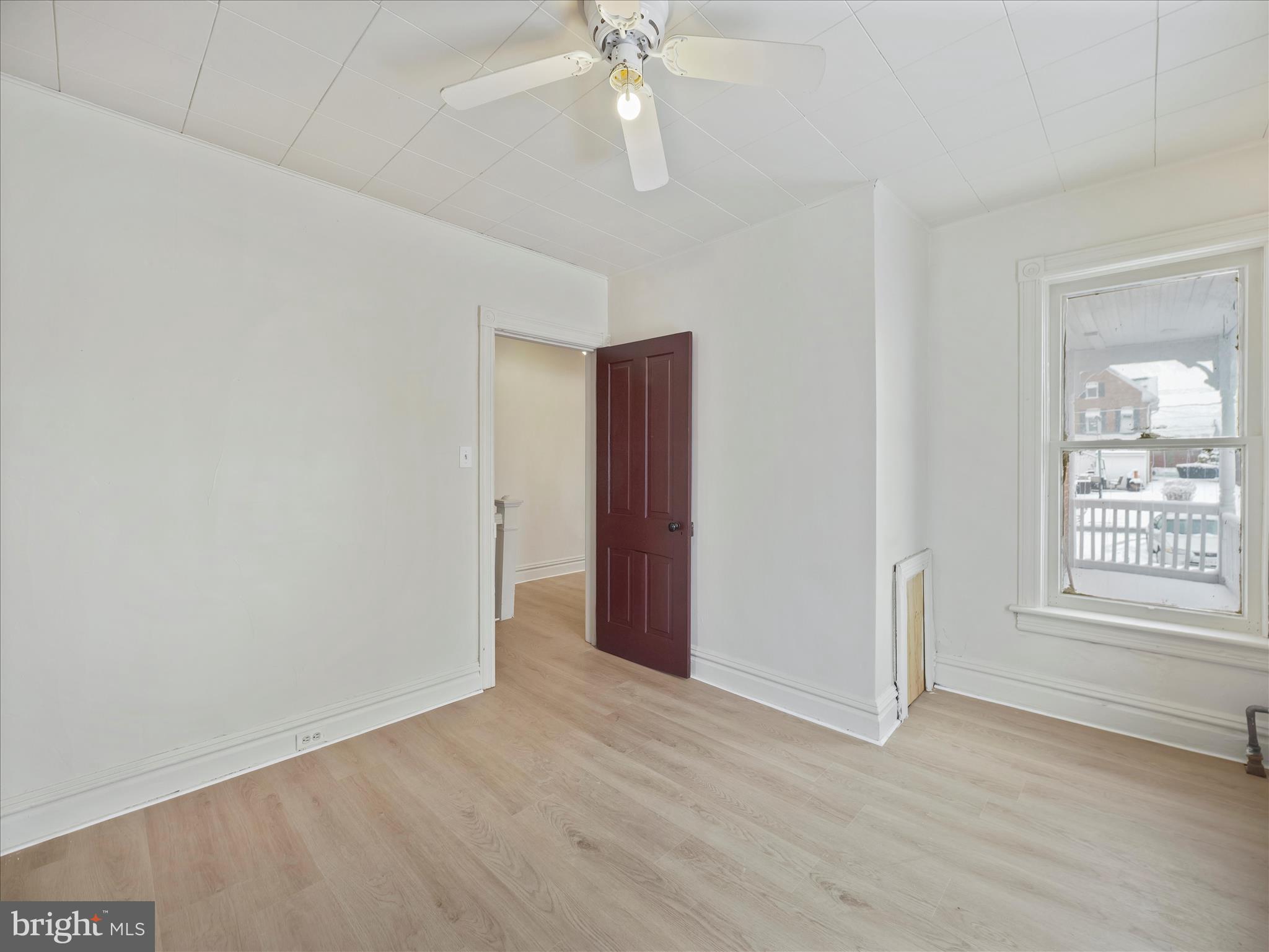 228 Ridge Avenue Waynesboro, PA 17268 - Photo 17 of 32 an empty room with wooden floor chandelier fan and windows
