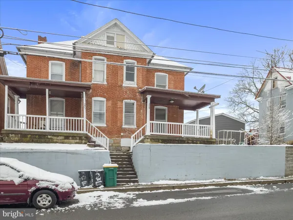 a front view of a house with parking space