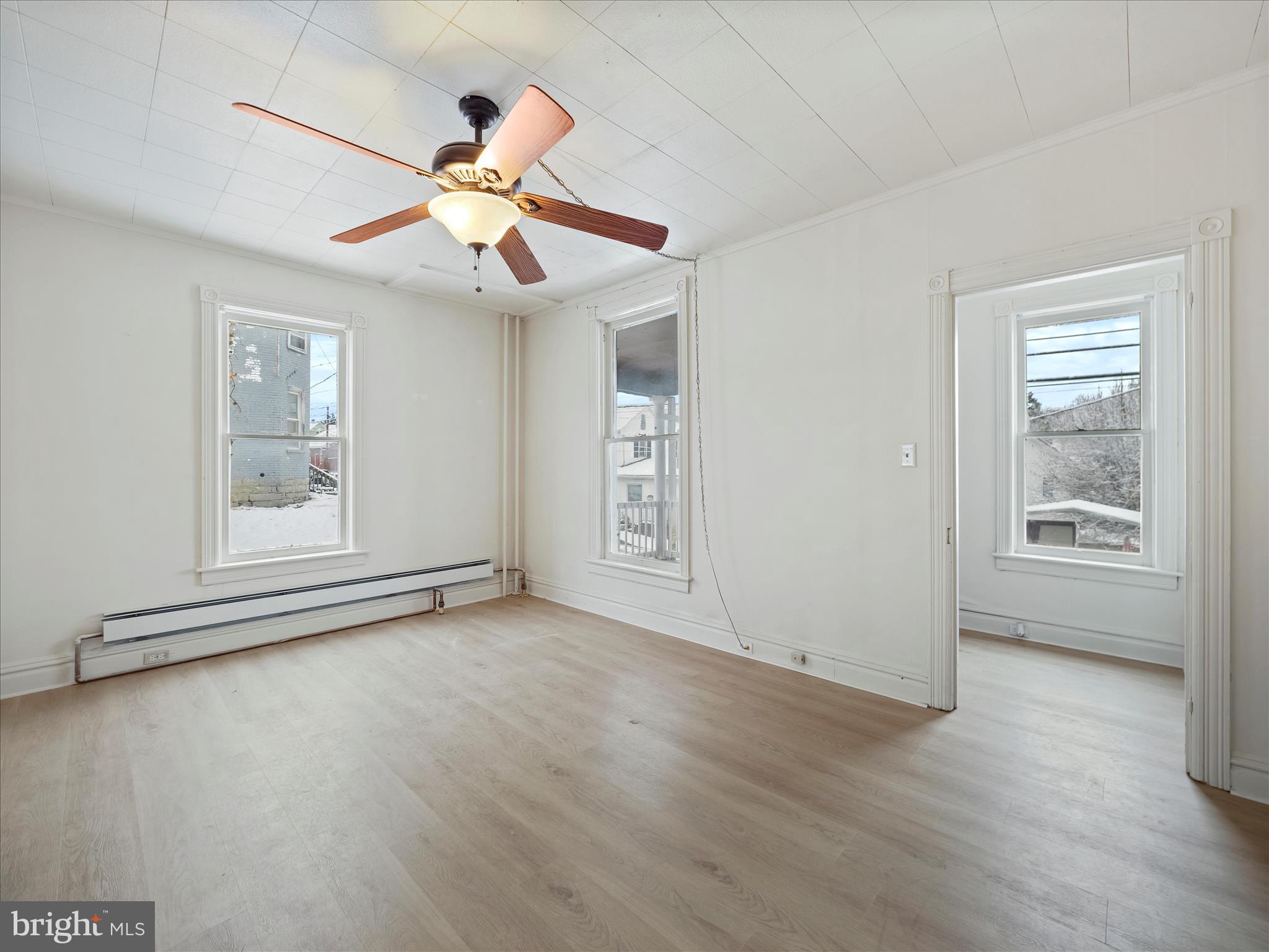 228 Ridge Avenue Waynesboro, PA 17268 - Photo 6 of 32 a view of an empty room with window and wooden floor