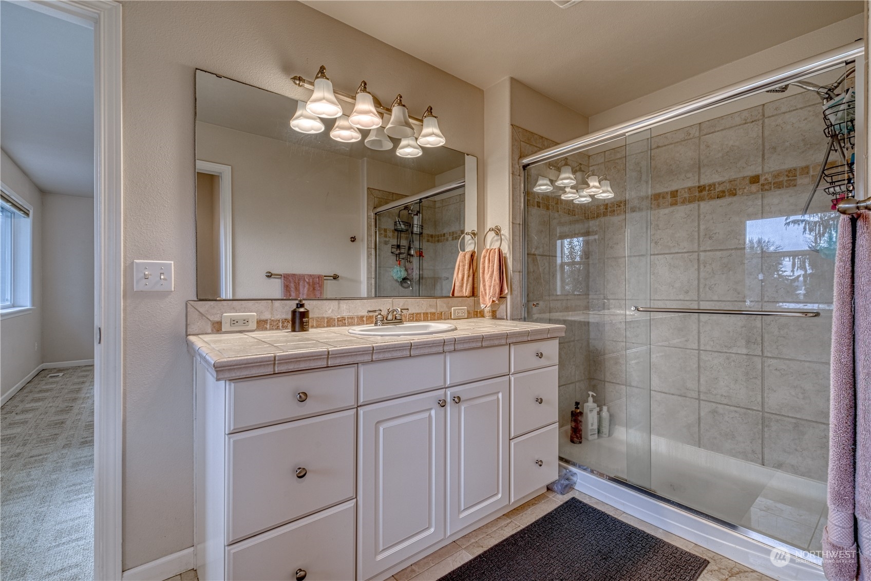 70 Northeast Wagon Wheel Road Belfair, WA 98528 - Photo 22 of 33 a bathroom with a double vanity sink mirror and shower
