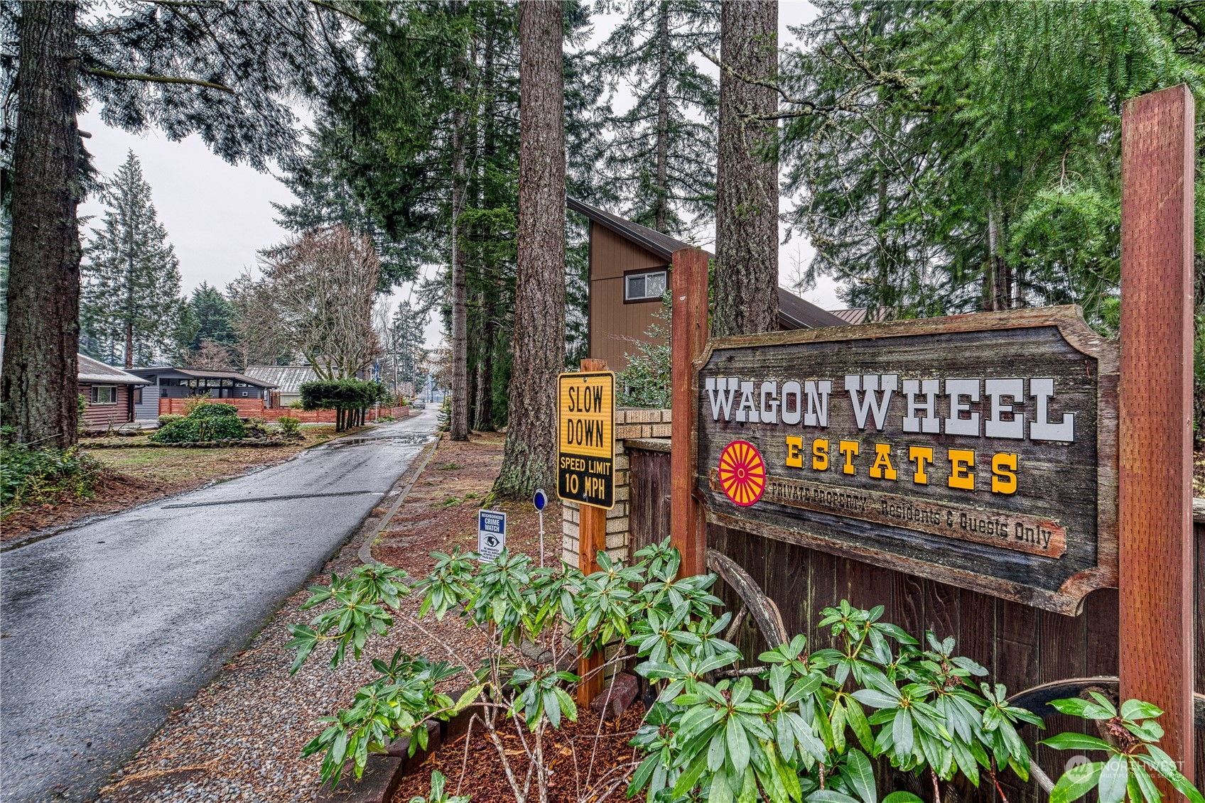 70 Northeast Wagon Wheel Road Belfair, WA 98528 - Photo 26 of 33 a view of a park with bench plants and large trees