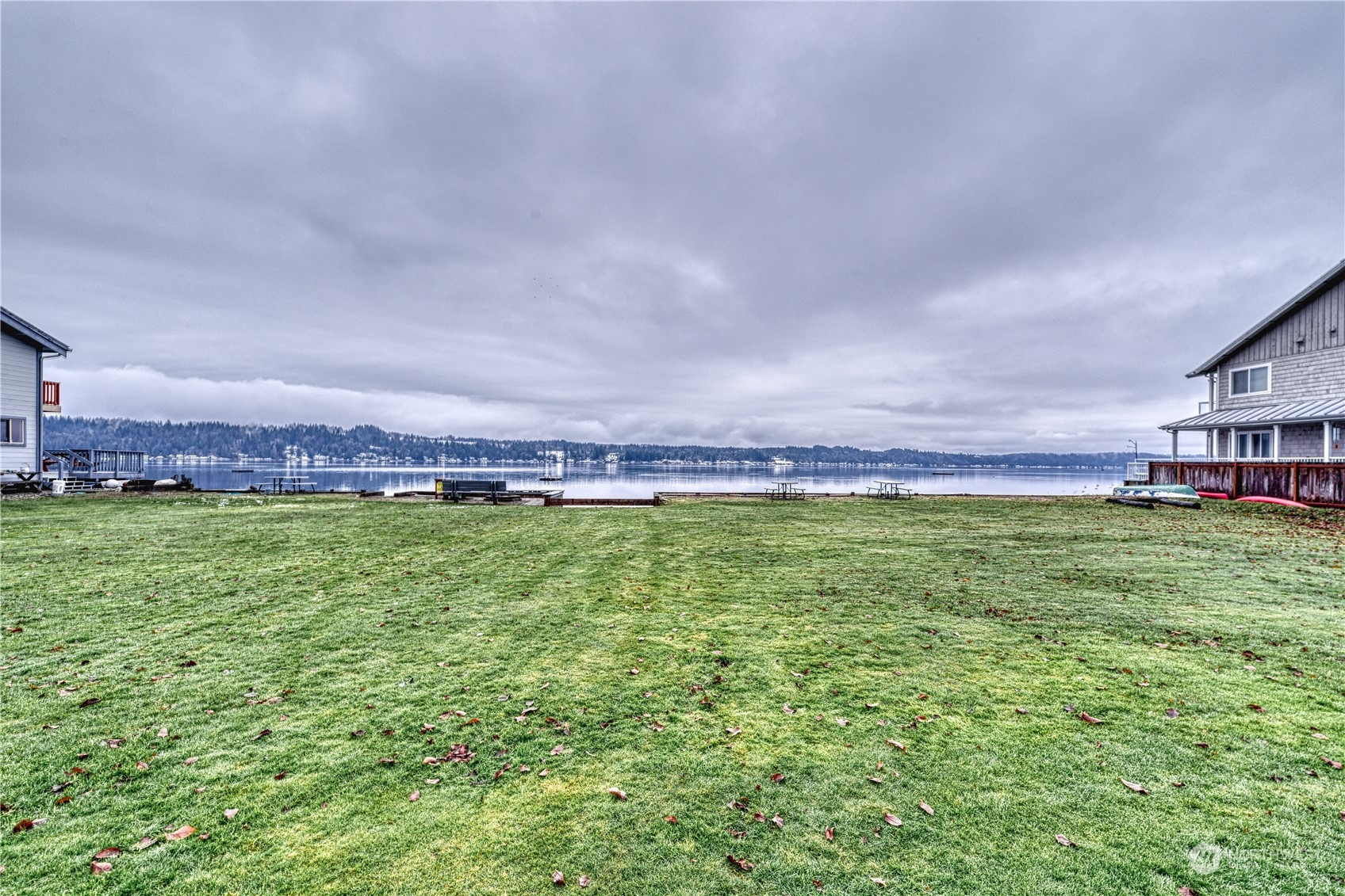 70 Northeast Wagon Wheel Road Belfair, WA 98528 - Photo 27 of 33 a view of a big yard with a large pool and a bench in the middle