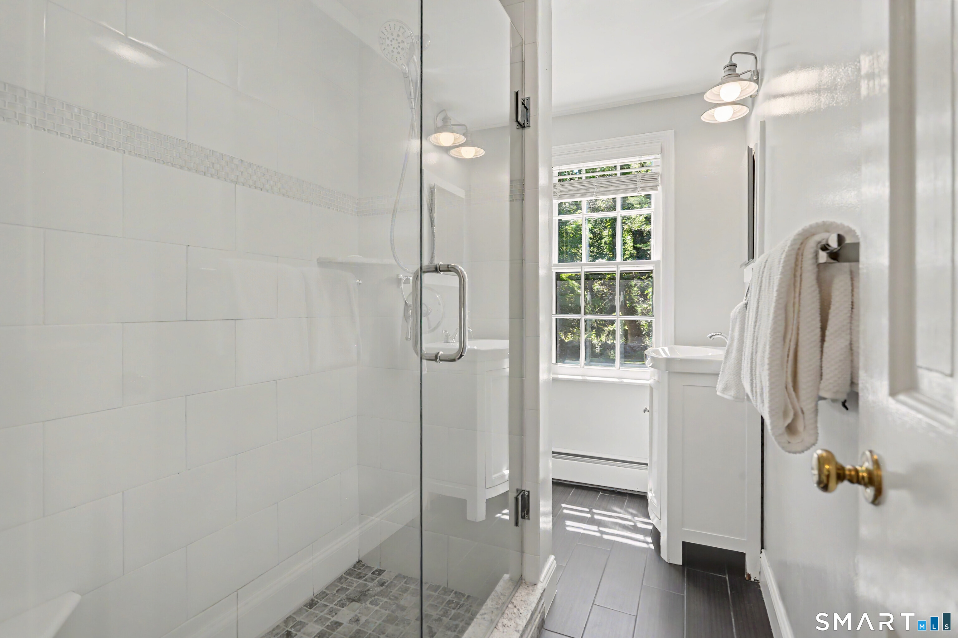 31 Vista Road Wilton, CT 06897 - Photo 20 of 34 Updated first-floor full bath with a frameless glass shower and classic tile finishes.