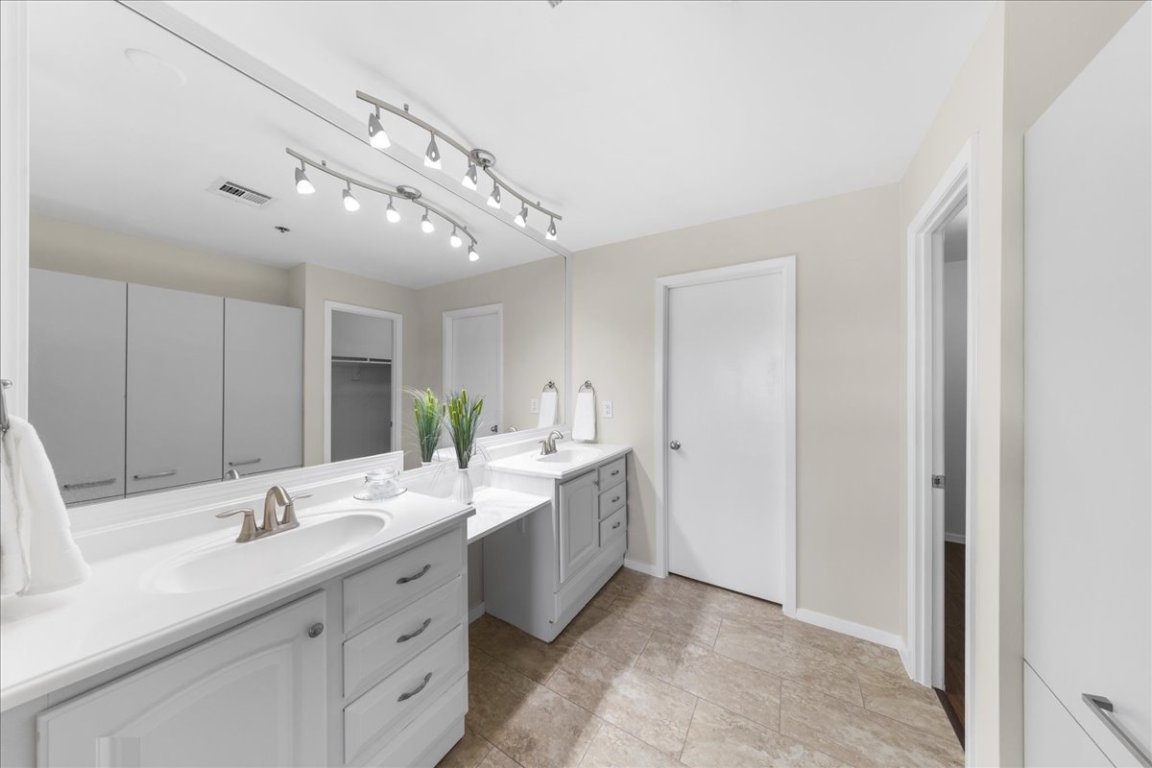 40 North Interstate Highway 35, Unit 6B3 Austin, TX 78701 - Photo 11 of 32 a bathroom with a double vanity sink and a mirror