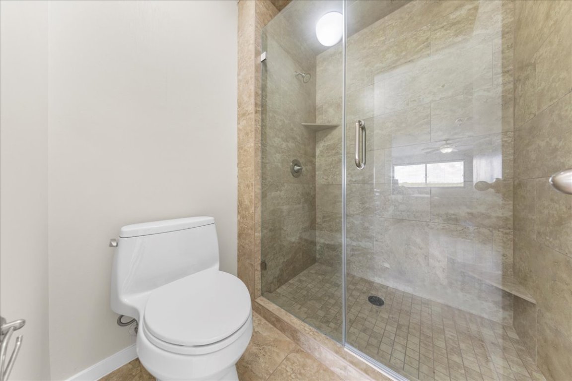 40 North Interstate Highway 35, Unit 6B3 Austin, TX 78701 - Photo 13 of 32 a bathroom with a shower and toilet