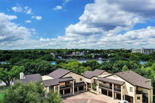 a bathroom with a bathtub shower sink mirror vanity and toilet
