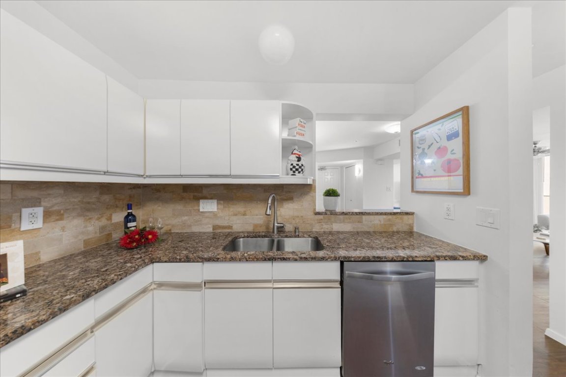 40 North Interstate Highway 35, Unit 6B3 Austin, TX 78701 - Photo 5 of 32 a kitchen with stainless steel appliances granite countertop a sink dishwasher and cabinets with wooden floor