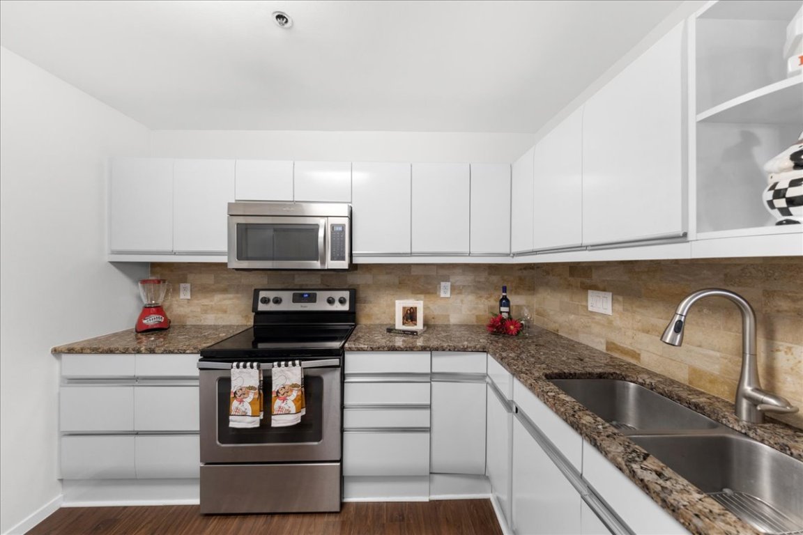 40 North Interstate Highway 35, Unit 6B3 Austin, TX 78701 - Photo 6 of 32 a kitchen with stainless steel appliances granite countertop a stove and a sink