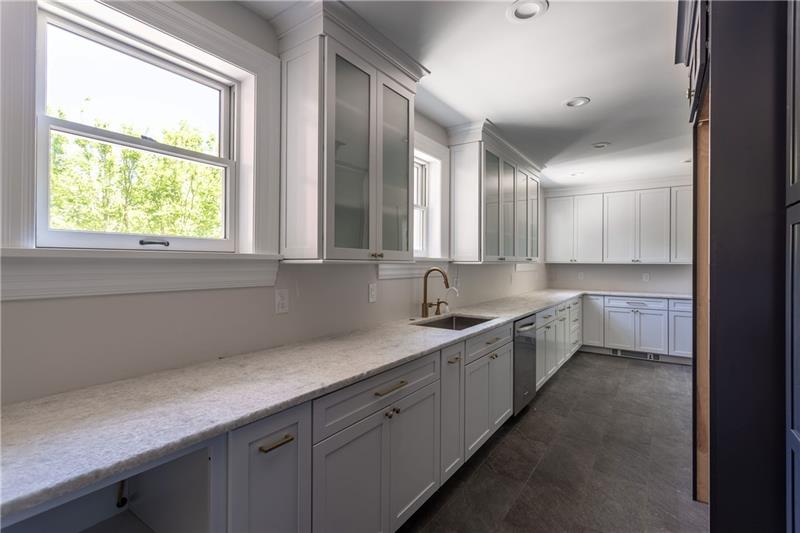 520 Pine Road Sewickley, PA 15143 - Photo 7 of 23 Adjacent to the kitchen is the butler's pantry. It's the perfect place to prepare for entertaining. An additional dishwasher, radiant-heated flooring, and ample storage complete the space.