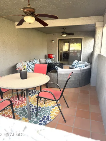 a view of living room filled with furniture and a floor to ceiling window