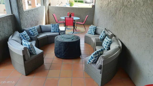 a room with pool table and a potted plant