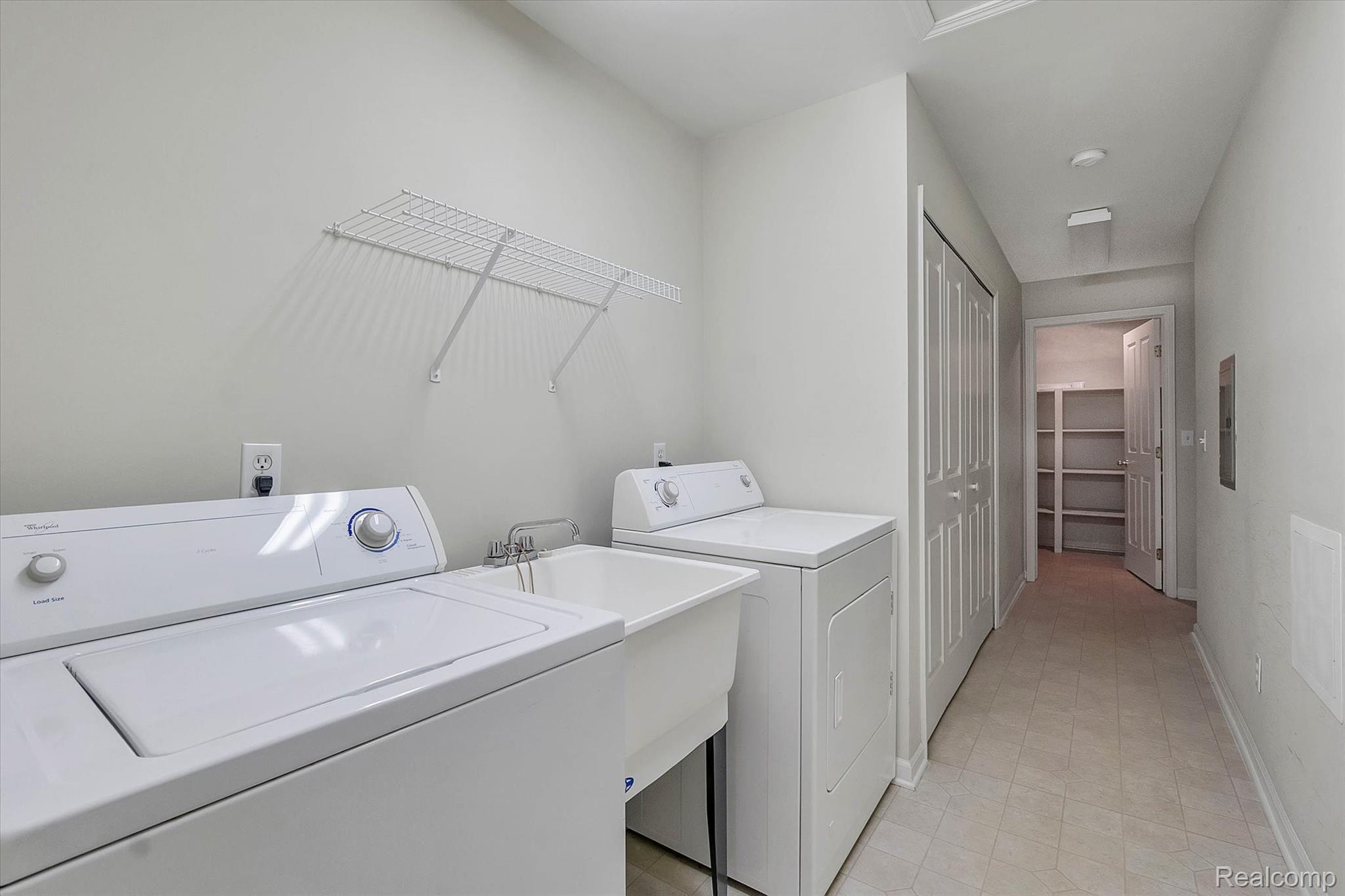 4069 Hampton Ridge Boulevard Howell, MI 48843 - Photo 16 of 30 laundry area is off the kitchen, along with mechanicals in closet on left hand side and large storage room at the end of the hallway.