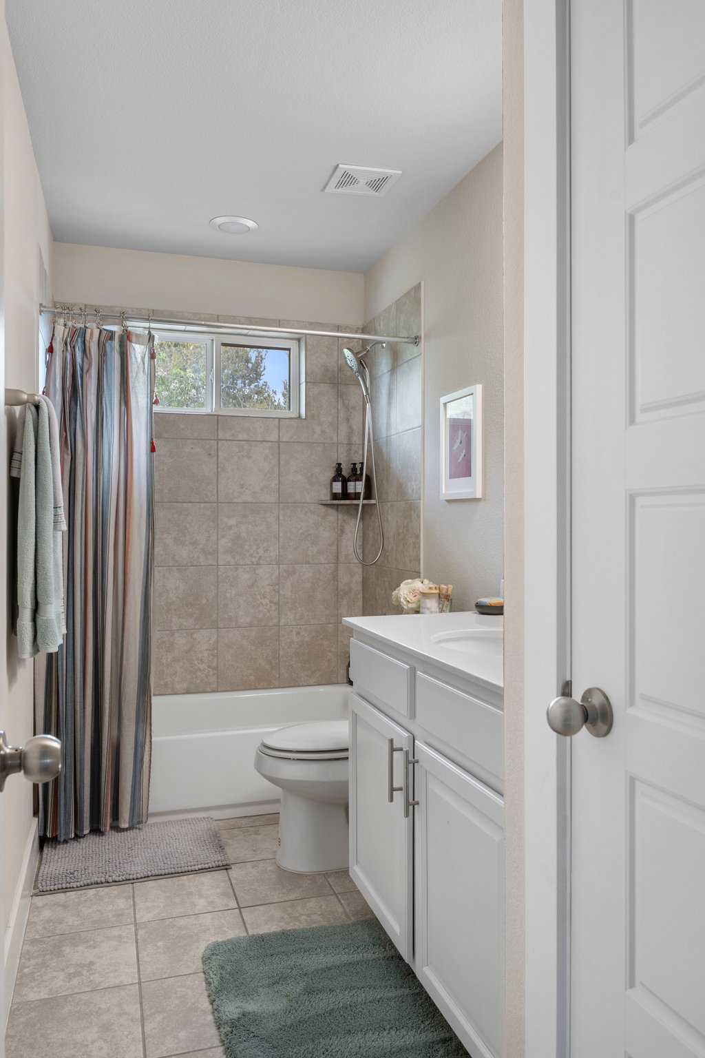 610 Bernstein Street, Unit 14 Austin, TX 78745 - Photo 28 of 39 Bathroom with vanity, shower / bath combination with curtain, and light tile patterned flooring