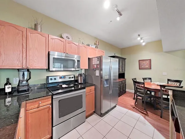 a kitchen with stainless steel appliances a stove a sink refrigerator and cabinets