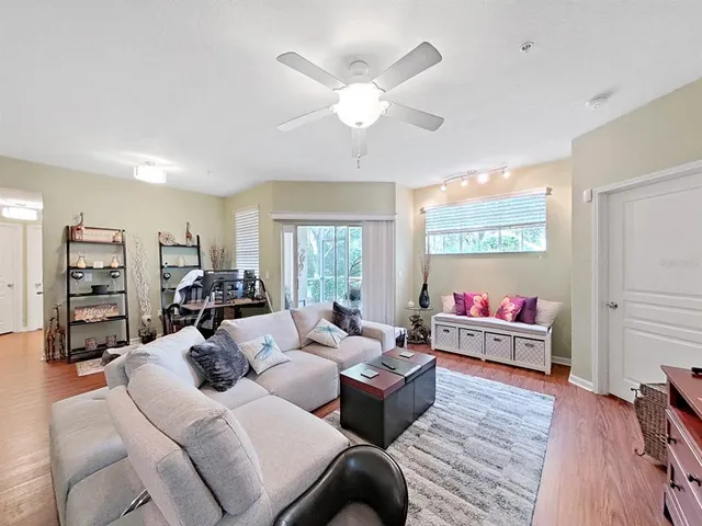 a living room with furniture and wooden floor