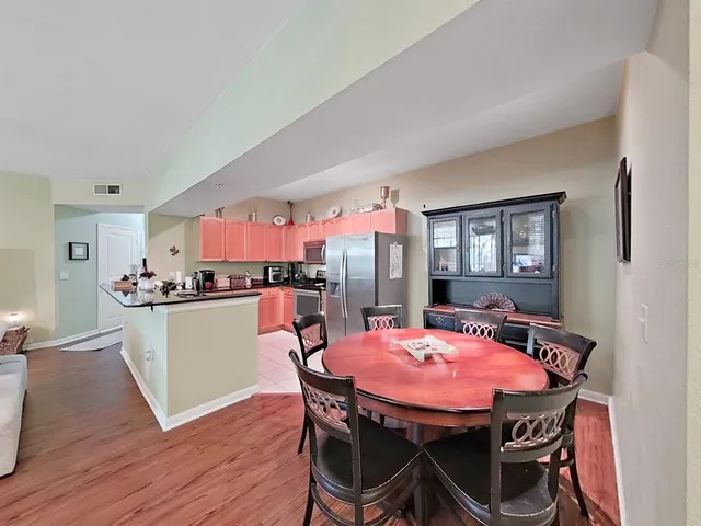 a view of a dining room with furniture and wooden floor