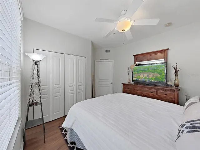 a bedroom with a bed and a chandelier