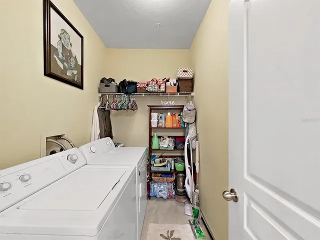 a spacious bedroom with a bed and wooden floor