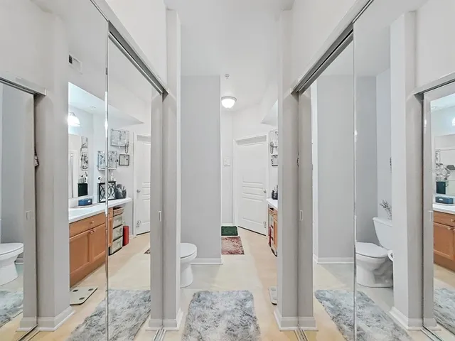 a bathroom with a toilet a sink and mirror