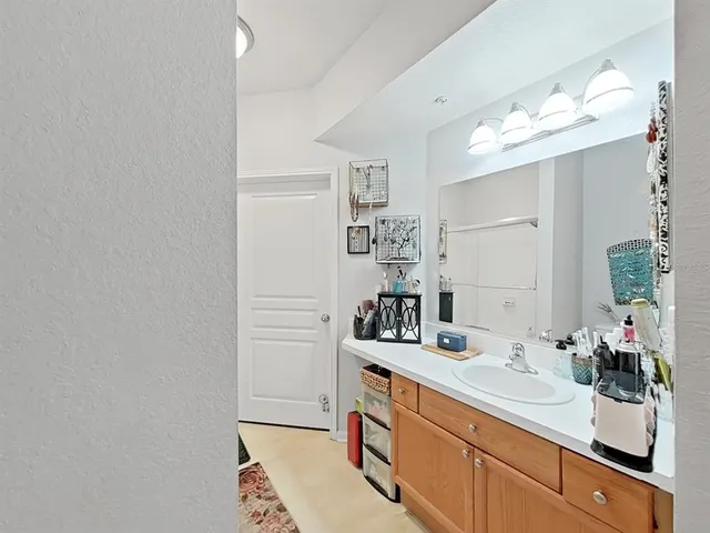 a bathroom with a sink a mirror and a shower