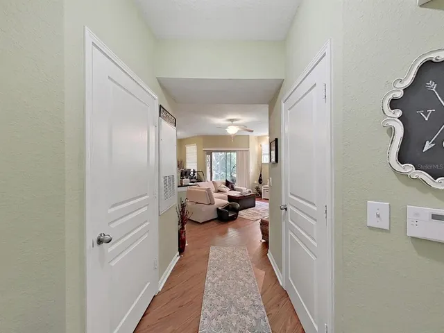 a view of a hallway with a livingroom and couch
