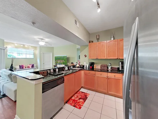 a kitchen with stainless steel appliances a sink stove and refrigerator