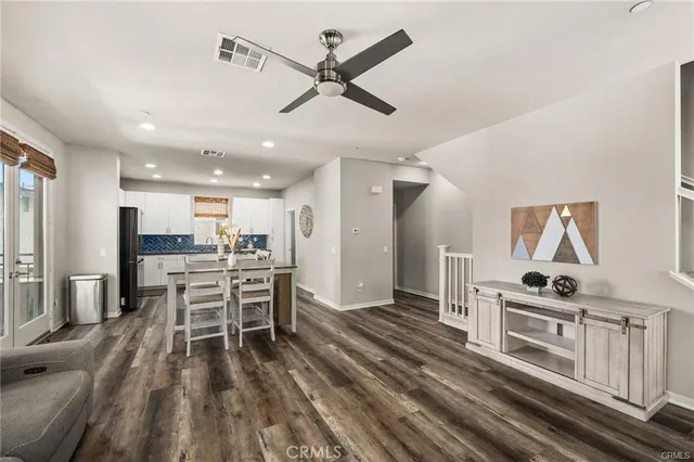 a kitchen with stainless steel appliances a stove a table and chairs