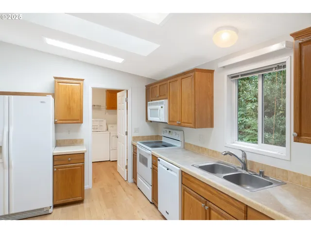 a kitchen with a sink stove and refrigerator
