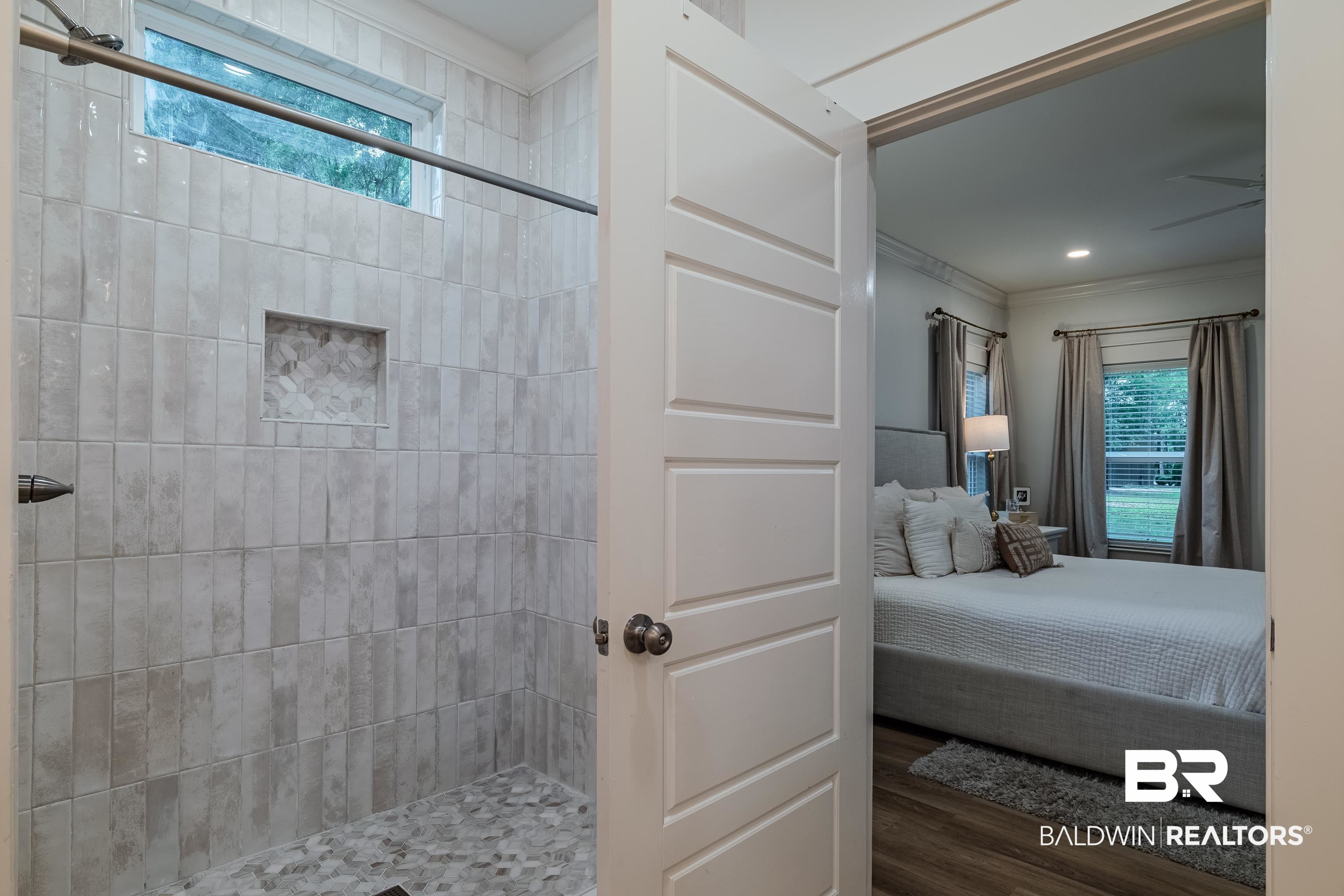 19121 Boothe Road Fairhope, AL 36532 - Photo 20 of 41 Ensuite bathroom with crown molding, a shower stall, and dark wood-style flooring