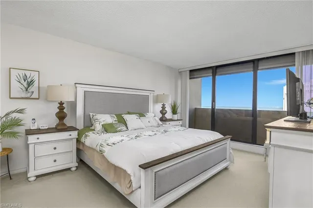 a large white bed in a white room