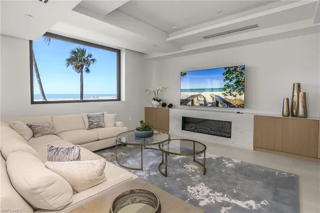 a living room with furniture a rug and a wall painting