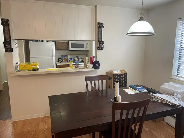 a view of a dining room with furniture and window