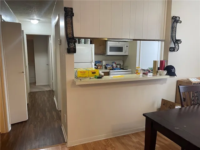 a kitchen with sink cabinets and wooden floor