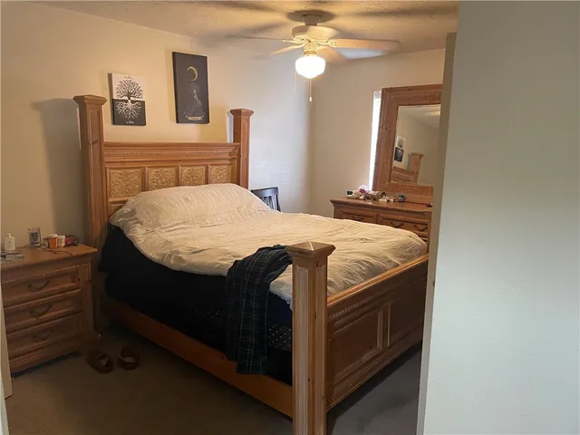 a bed sitting in a bedroom and mirror