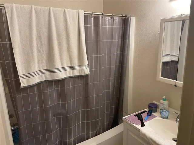 a bathroom with a sink and a shower curtain
