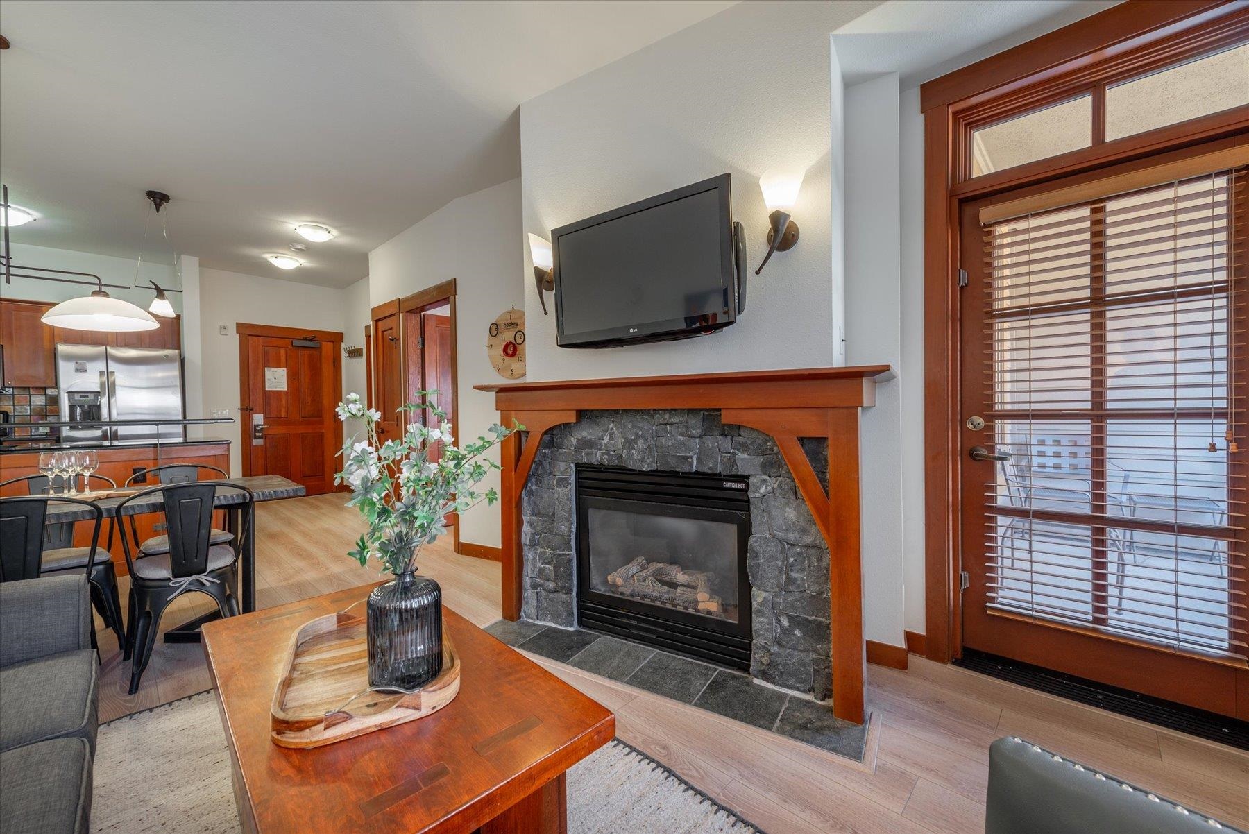 1850 Village South Road, Unit 4213 Olympic Valley, CA 96146 - Photo 1 of 17 a living room with furniture a flat screen tv and a fireplace