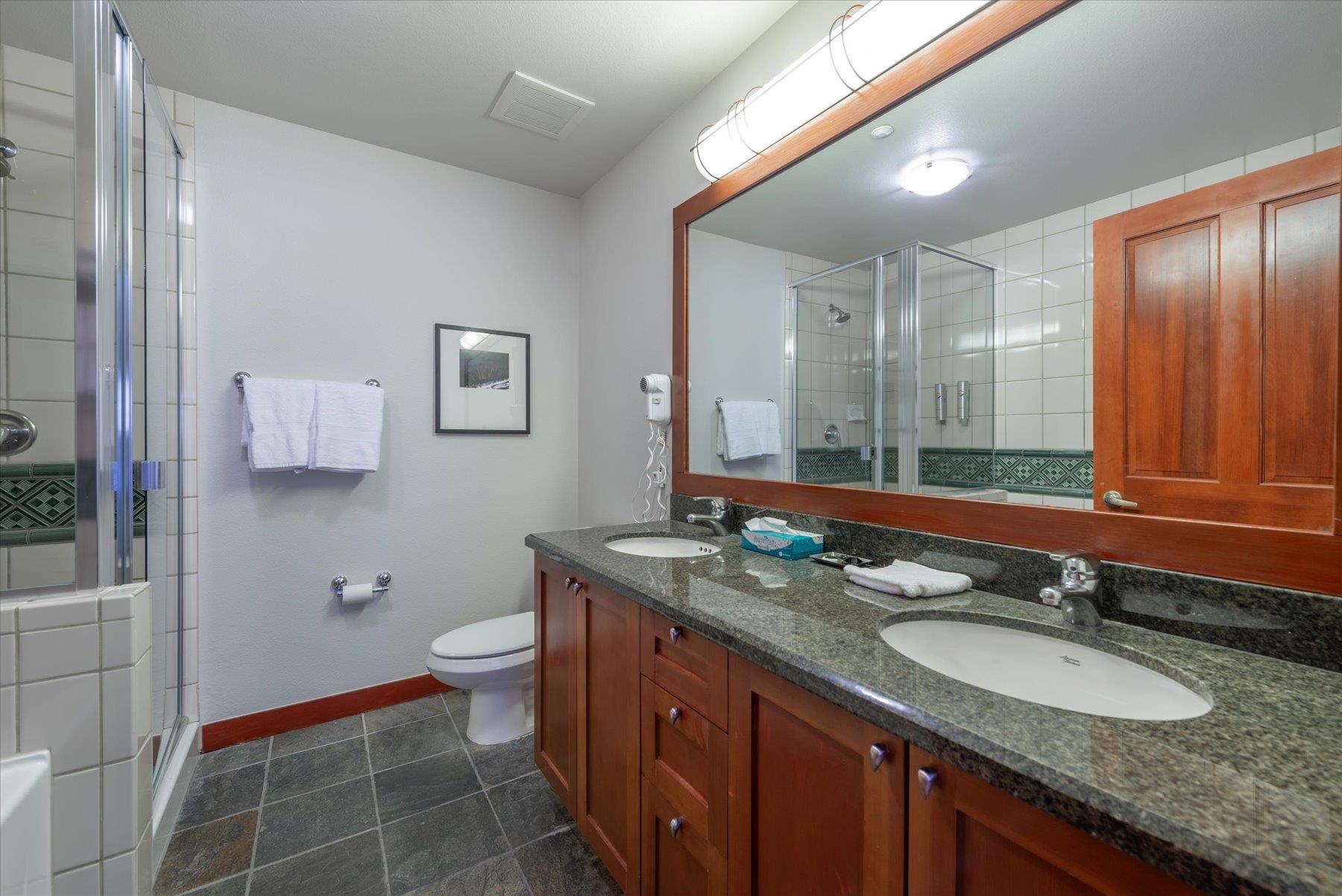 1850 Village South Road, Unit 4213 Olympic Valley, CA 96146 - Photo 13 of 17 a bathroom with a granite countertop double vanity sink a mirror and a toilet
