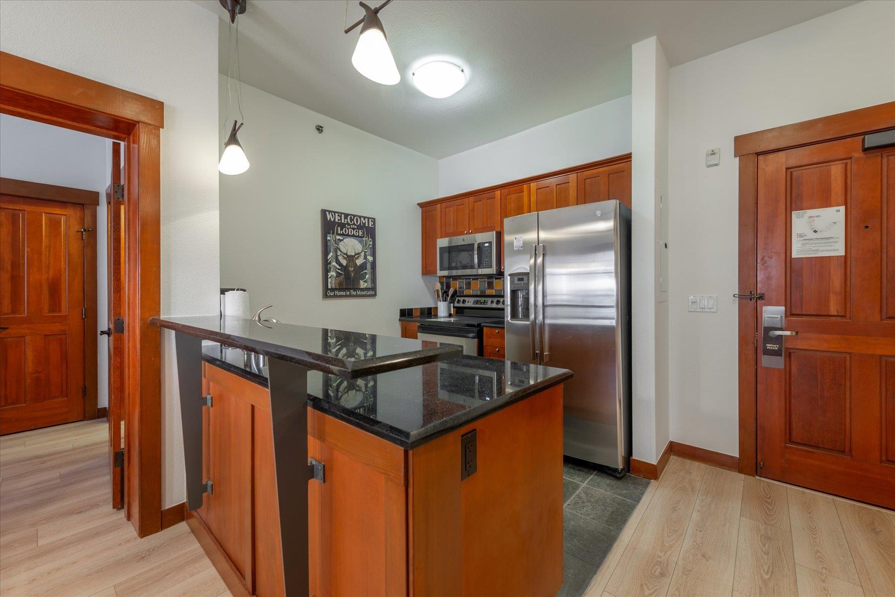 1850 Village South Road, Unit 4213 Olympic Valley, CA 96146 - Photo 5 of 17 a kitchen with stainless steel appliances granite countertop a refrigerator a sink and a stove