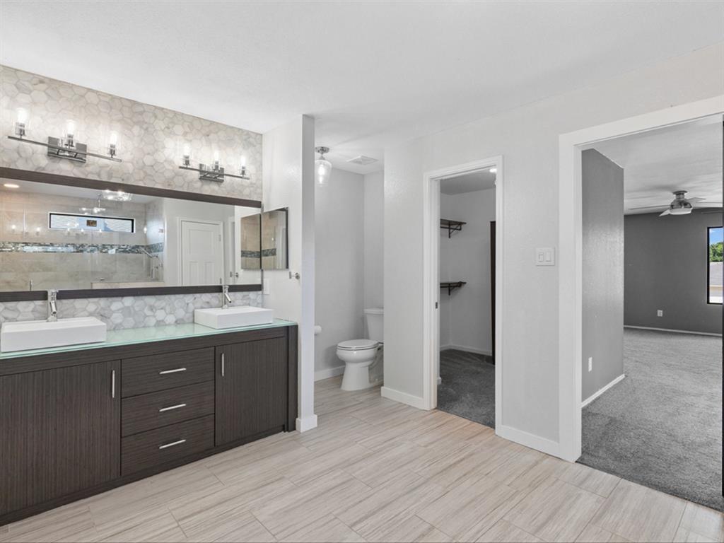 5304 Los Altos Road Fort Worth, TX 76244 - Photo 22 of 30 Full bath with double vanity, ceiling fan, and tiled shower