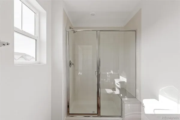 a bathroom with a glass shower door