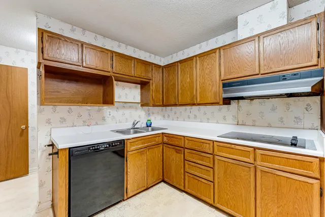 a kitchen with stainless steel appliances granite countertop a refrigerator and microwave