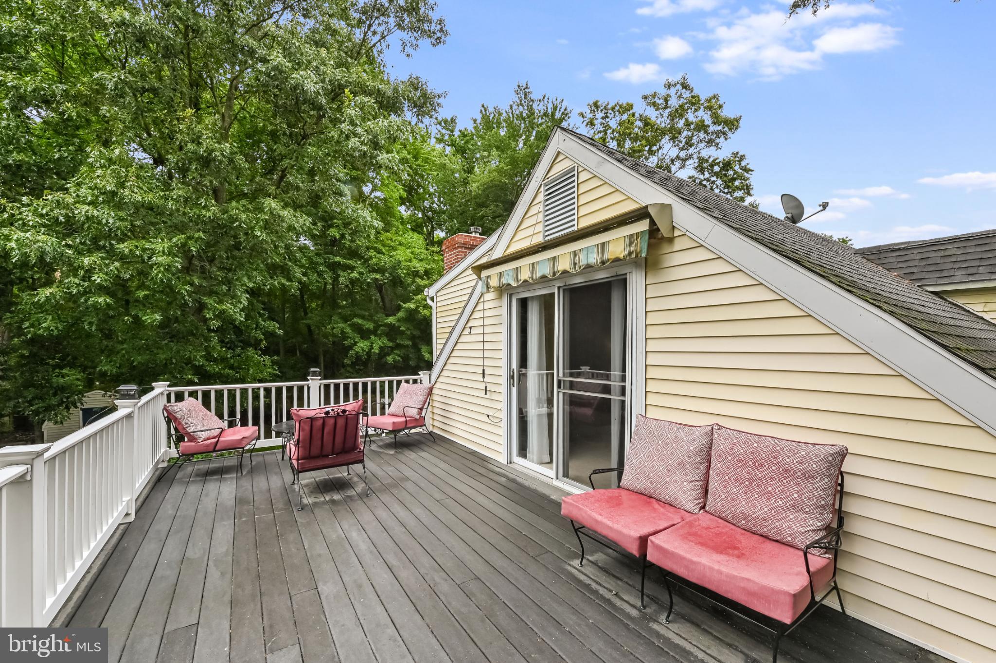 26698 Arcadia Shores Road Easton, MD 21601 - Photo 31 of 71 a view of a deck with couches table and chairs with wooden floor